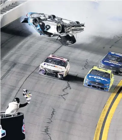  ?? DAVID GRAHAM/AP ?? Ryan Newman’s car goes airborne as Denny Hamlin, front left, passes Ryan Blaney at the conclusion of the Daytona 500 on Monday.