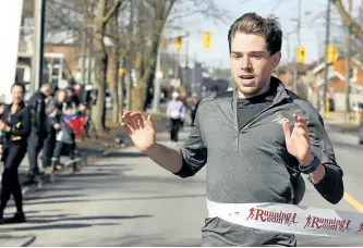  ?? CLIFFORD SKARSTEDT/EXAMINER ?? Ross Proudfoot was the first runner to cross the finish line, in record time, during the YMCA Half-Marathon at Central East Region YMCA on Sunday. See page D1 for more photos from the event.