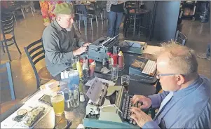  ?? THE ASSOCIATED PRESS ?? In this April 23 photo, Joe Van Cleave (left) and Rich Boucher try out various vintage typewriter­s at a “type-in” in Albuquerqu­e, N.M. “Type-ins” are social gatherings in public places where typewriter fans test different vintage machines