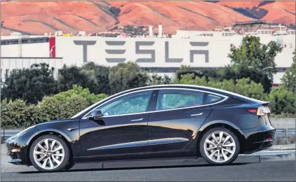  ?? Courtesy of tesla Motors via ap ?? This undated image provided by Tesla Motors shows the Tesla Model 3 sedan. The electric car company’s newest vehicle, the Model 3, is half the cost of previous models.