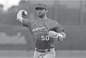  ??  ?? Cardinals pitcher Adam Wainwright throws during a spring training practice Wednesday in Jupiter, Fla. JEFF ROBERSON/AP