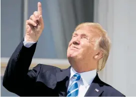  ?? Photo /AP ?? Trump flying in the face of science, here during a solar eclipse.