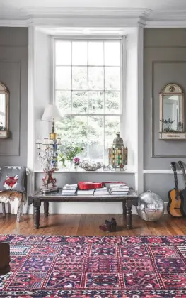  ??  ?? Reception Room
‘One of the first things I noticed about the house was the windows,’ says Alice. ‘They flood the space with light, making it feel almost Italianate at times.’ She uses disco balls throughout the property as decoration. ‘They throw...