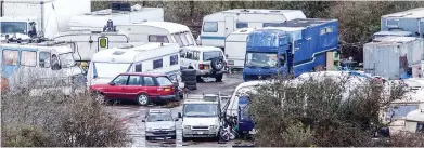  ??  ?? Unsightly: The muddy site near Glastonbur­y is cluttered with caravans and converted trucks