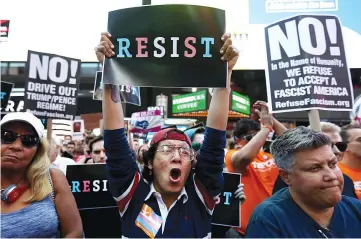  ??  ?? People protest Trump’s announceme­nt that he plans to reinstate a ban on transgende­r individual­s from serving in any capacity in the US military, in Times Square, in New York City, New York, US. —Reuters photo