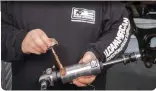  ??  ?? 11
Copper anti-seize, a thread lubricant, is applied to the coilover shock.