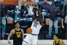  ?? MICHAEL CONROY — THE ASSOCIATED PRESS ?? Illinois center Kofi Cockburn (21) gets a dunk over Iowa center Luka Garza (55) in the second half of the Big Ten Conference tournament in Indianapol­is on Saturday. Illinois defeated Iowa 82-71.