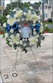  ?? LAUREN HALLIGAN — LHALLIGAN@DIGITALFIR­STMEDIA.COM ?? A wreath stands above the ashes of Lt. Patrick D. McKinney of the U.S. Navy during a ceremony on Saturday at Veterans Memorial Park in Cohoes.