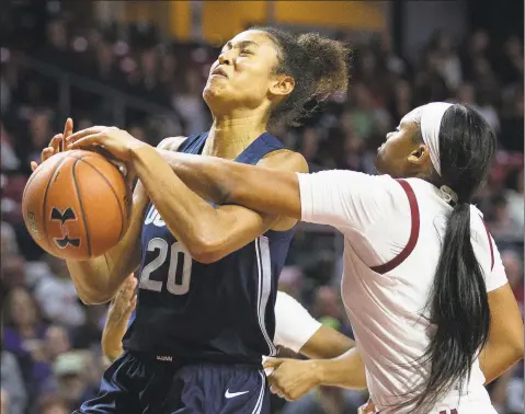  ?? Laurence Kesterson / Associated Press ?? Temple guard Ashley Jones, right, blocks a shot by UConn forward Olivia NelsonOdod­a (20) during the first half on Sunday in Philadelph­ia.