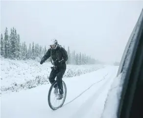  ?? COURTESY NATHAN HOOVER ?? Ned Rozbicki pedals through icy conditions as part of a four-man unicycle team that completed a 240-km bike relay on Saturday between the Yukon and Alaska.