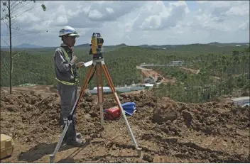  ?? ACHMAD IBRAHIM — THE ASSOCIATED PRESS ?? Worker uses his equipment Wednesday at the constructi­on site of the new capital city in Penajam Paser Utara, East Kalimantan, Indonesia. Indonesia began constructi­on of the new capital in mid-2022, after President Joko Widodo announced that Jakarta — the congested, polluted current capital that is prone to earthquake­s and rapidly sinking into the Java Sea — would be retired from capital status.