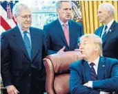  ?? GETTY ?? President Donald Trump speaks with Senate Majority Leader Mitch McConnell during a bill signing ceremony for the CARES Act on March 27 in Washington, D.C.