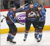  ?? David Zalubowski / Associated Press ?? Colorado Avalanche right wing Mikko Rantanen, center, celebrates his overtime goal with defensemen Cale Makar, left, and Tyson Barrie in Game 4 of a playoff series against the Calgary Flames in 2019.