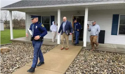  ?? ?? Michigan state police exit Adams Township Hall after executing a search warrant on 29 October 2021, in Hillsdale, Michigan. Photograph: Corey Murray/AP