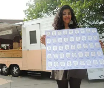  ?? TAMAR HARRIS/TORONTO STAR ?? Toronto-based artist Farrah-Marie Miranda holds a poster with quotes from migrant workers.