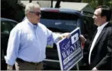  ?? ASSOCIATED PRESS ?? Republican candidate for Pennsylvan­ia governor Scott Wagner, left, hands off campaign signs as he arrives at a polling station Tuesday in Springfiel­d.