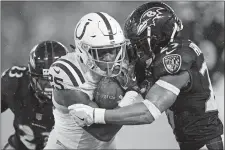  ?? NICK WASS/AP PHOTO ?? Colts running back Marlon Mack (25) is stopped by Ravens defensive back Marlon Humphrey (29) during Saturday’s game at Baltimore.