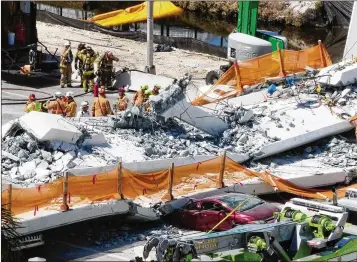  ?? ROBERTO KOLTUN / MIAMI HERALD ?? Rescuers search through the rubble of the FIU pedestrian bridge, which collapsed March 15, resulting in six deaths. A judge Tuesday ordered state transporta­tion officials to hand over records related to the collapse.