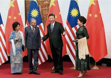  ??  ?? Renewed partnershi­p: Dr Mahathir and wife Tun Dr Siti Hasmah Mohd Ali meeting Xi and his wife Peng Liyuan at the Diaoyutai StateGuest House in Beijing last year. During his four-day trip to China next week, Dr Mahathir is scheduled to meet Xi again for bilateral talks.