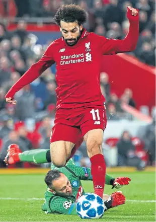  ?? Pictures: Getty Images. ?? Left: Lucas Moura turns away to celebrate after finally finding a way past Barcelona keeper Jasper Cillessen to equalise for Spurs. Above: Liverpool goal hero rounds Napoli keeper David Ospina during the Group C game at Anfield.