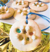  ??  ?? Colorful cookies represent medals featuring the Olympic rings using homemade edible glass.