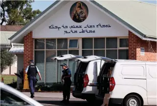  ?? AFP PHOTO ?? SACRED SPACE
Police officers and their vehicles are seen outside the Christ the Good Shepherd Church in Sydney’s western suburb of Wakeley, eastern Australia, on Tuesday, April 16, 2024.