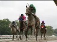  ?? BILL DENVER — EQUI‑PHOTO VIA AP ?? Travers favorite Exaggerato­r, center, with Kent Desormeaux riding, wins last month’s Haskell Invitation­al at Monmouth Park.