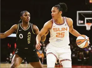  ?? Ethan Miller / Getty Images ?? Alyssa Thomas (25) of the Connecticu­t Sun is guarded by Jackie Young (0) of the Las Vegas Aces during their game at Michelob ULTRA Arena on June 2 in Las Vegas. The Sun defeated the Aces 97-90. Thomas was named to her third All-Star team on Tuesday.