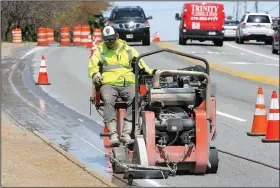  ?? NWA Democrat-Gazette/DAVID GOTTSCHALK ?? Luke Gilpatrick with Fayettevil­le’s Transporta­tion Division uses a cement cutter Tuesday on College Avenue in Fayettevil­le. The work is part of Phase II for completing the improvemen­t project on the west side of College Avenue between North and Maple...