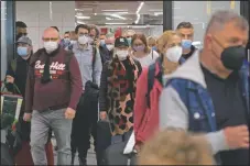  ?? (AP/Francisco Ubilla) ?? Passengers wearing face masks arrive at the airport in Mallorca.