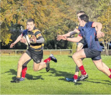  ??  ?? In top form Aidan Stott powers forward for East Kilbride and he went on to score two tries against Wigtownshi­re