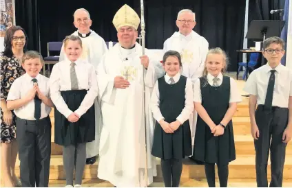  ??  ?? Celebratio­n Pictured at St Cuthbert’s are (back row) Father Bogan and Father Dornan with (front row) head teacher Martina Hendry, John Mcskimming, Eva Rowatt, Bishop Toal, Aimee Barrie, Kayla Mcginty and Marcus Leslie