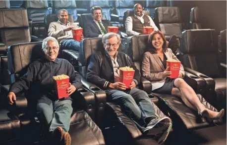  ??  ?? ERIC CURTIS, UNIVERSAL CITYWALK NBCUnivers­al vice chairman Ron Meyer (front left), Steven Spielberg, Universal Studios Hollywood president Karen Irwin, Jordan Peele ( back left), producer Jason Blum and filmmaker Will Packer test out luxury seats.