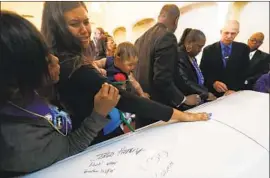  ?? Luis Sinco Los Angeles Times ?? ANTHONY “A.J.” WEBER, 16, was fatally shot by L.A. County sheriff ’s deputies last year. Above, his infant daughter, Violet, reaches for his casket on Feb. 24, 2018.