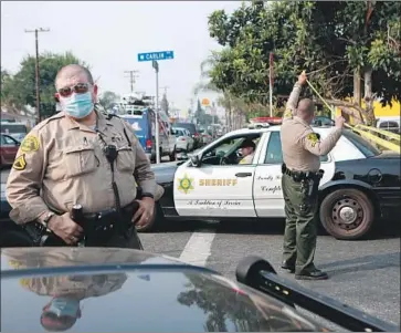  ?? Jason Armond Los Angeles Times ?? AS TWO deputies recover from a gun attack, Sheriff Alex Villanueva has accused politician­s and athletes of “fanning the f lames of hatred” during this time of unrest over police brutality. Above, deputies in Compton.