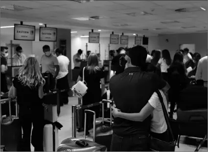  ?? AP Photo/Jorge Saenz ?? In this April 17 file photo, people check in for a flight to Miami at Silvio Pettirossi Airport, in Luque, Paraguay.