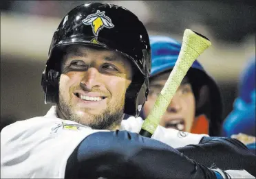  ?? Sean Rayford ?? Former NFL quarterbac­k/ Heisman Trophy winner-turned- budding baseball outfielder
Tim Tebow waits to hit for the Class-a Columbia Fireflies last April in Columbia, S.C.
The Associated Press