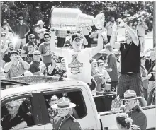  ?? CANADIAN PRESS FILE PHOTO ?? Pittsburgh Penguins’ Sidney Crosby hoists the Stanley Cup at a parade through his hometown of Cole Harbour, N.S., on July 16, 2016.