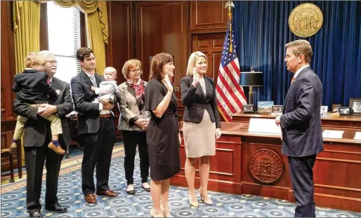  ?? FACEBOOK ?? Gov. Brian Kemp’s spokeswoma­n, Candice Broce (second from right), shown taking an oath after he was sworn in as governor in January 2019, still insisted last month that elections officials responded to a “failed cyber intrusion,” despite GBI findings that scans came from DHS.