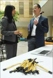  ?? BRENT DAVIS, RECORD STAFF ?? Hockeystic­k founder Raymond Luk discusses his company’s scaleup data platform with Waterloo MP Bardish Chagger.