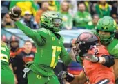 ?? ANDY NELSON AP ?? Oregon quarterbac­k Anthony Brown Jr. throws a pass in the No. 11 Ducks’ win over rival Oregon State.