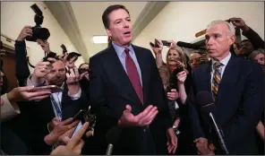  ?? AP/J. SCOTT APPLEWHITE ?? Former FBI Director James Comey pauses in a hallway to speak with reporters Friday after a closed interview with the House Judiciary Committee.