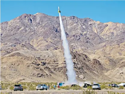 ??  ?? Mike Hughes’s home-made rocket propelled him about 1,875ft into the air, left. After he deployed the parachute, right, a hard landing in the Mohave Desert left him injured, below