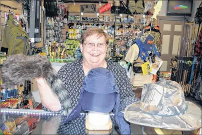  ?? SHARON MONTGOMERY-DUPE/CAPE BRETON POST ?? Karen Barry, owner of Hunted Treasures in Whitney Pier, holds a variety of hats for sale in her store which actually specialize­s in fly-tying, fishing and hunting items.