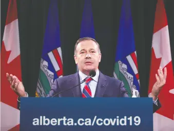  ?? TODD KOROL/THE CANADIAN PRESS ?? As ICU wards fill with COVID patients, Premier Jason Kenney has reversed course on COVID restrictio­ns and the province is looking to other provinces to handle the overflow.