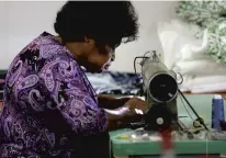  ?? STEPHEN M. KATZ PHOTOS/STAFF ?? Daphne Fiedtkou sews surgical masks at The Designer Workshop in Virginia Beach on April 9 to help fill the increased demand.