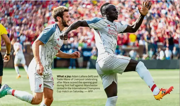  ?? — AFP ?? What a joy: Adam Lallana (left) and Sadio Mane of Liverpool celebratin­g after Mane scored the opening goal during first half against Manchester United in the Internatio­nal Champions Cup match on Saturday.