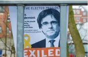  ?? (AFP) ?? A portrait of former Catalan leader Carles Puigdemont behind the fence of a prison in Germany, where Puigdemont is detained