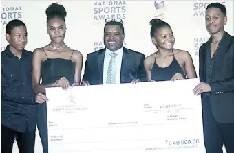  ?? (Pics: Nimrod Hlophe) ?? 2022 Malawi Region V Taekwondo Team was also awarded with a E40 000 replica cheque for the five gold medals they won. They are (L-R) Gcinizwi Nxumalo, Sivunwesih­le Dlamini, Zakhele Dlamini standing in for Hlelo Vilakati, Kuye Dlamini and Sihlelelwe Matsebula during the National Sports Awards held at Happy Valley Hotel yesterday.
