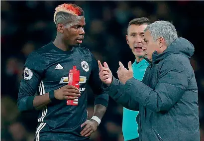  ?? — AFP ?? Manchester United manager Jose Mourinho talks with midfielder Paul Pogba during a Premier League match.